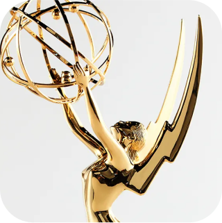 A gold Emmy Award statue, featuring a winged woman holding up an atom-like structure. The background is plain white.