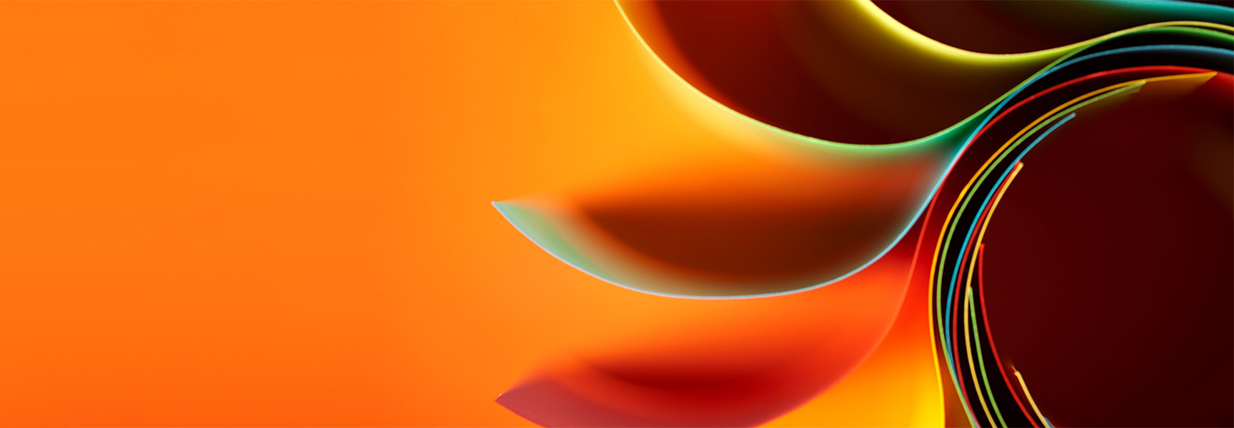 Abstract image featuring layered, curved shapes with a gradient of orange, yellow, and red hues. The design creates a sense of depth and movement from left to right, with smooth transitions between colors.