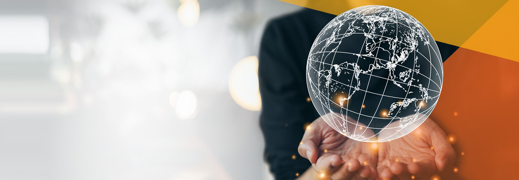 A person extends their hands, cupping a luminous digital globe adorned with world map lines, embodying corporate social responsibility. The backdrop is abstract, featuring a serene blend of bokeh lights and geometric shapes in hues of orange and gray.