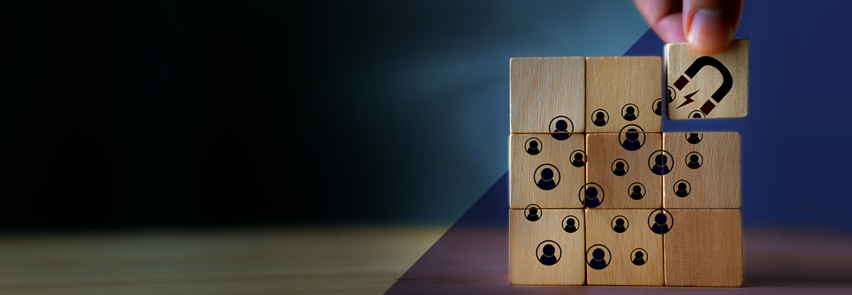 A hand places a wooden block with a question mark onto a grid of blocks, inviting intrigue much like the way youd hook customers into your loyalty program. The other blocks display people icons, forming a unified square on a wooden table against a gradient dark blue background.