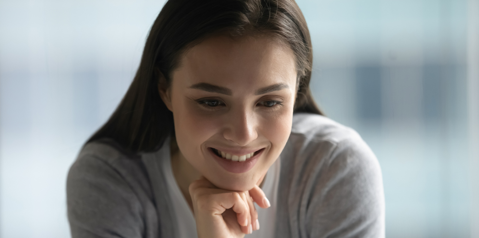 Great. Happy smiling young woman reading good news from pc screen at workplace in office feeling happy glad receiving reward for perfect job, getting greeting recognition from company leader by email